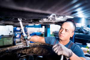 Mechaniker beim Wechsel des Motoröls für einen VW